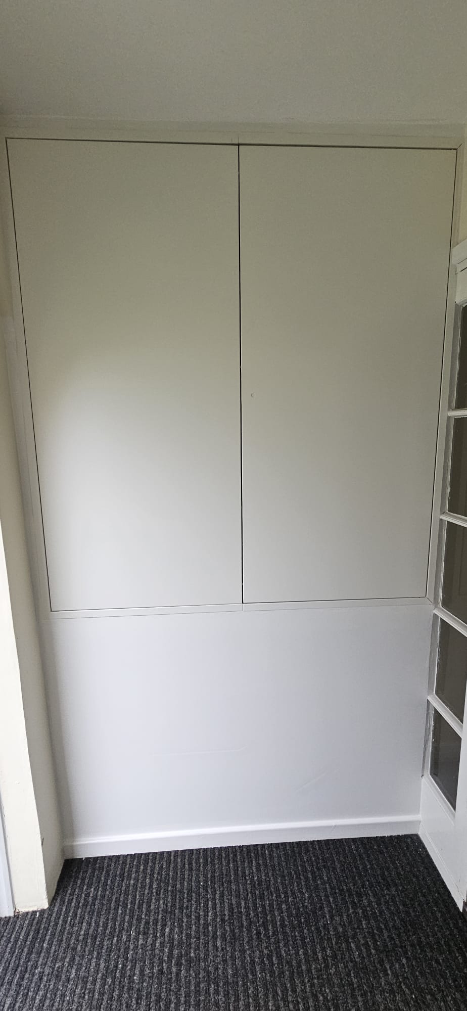 Completed compartmentation boxing to a service riser — sealed, painted and handed over