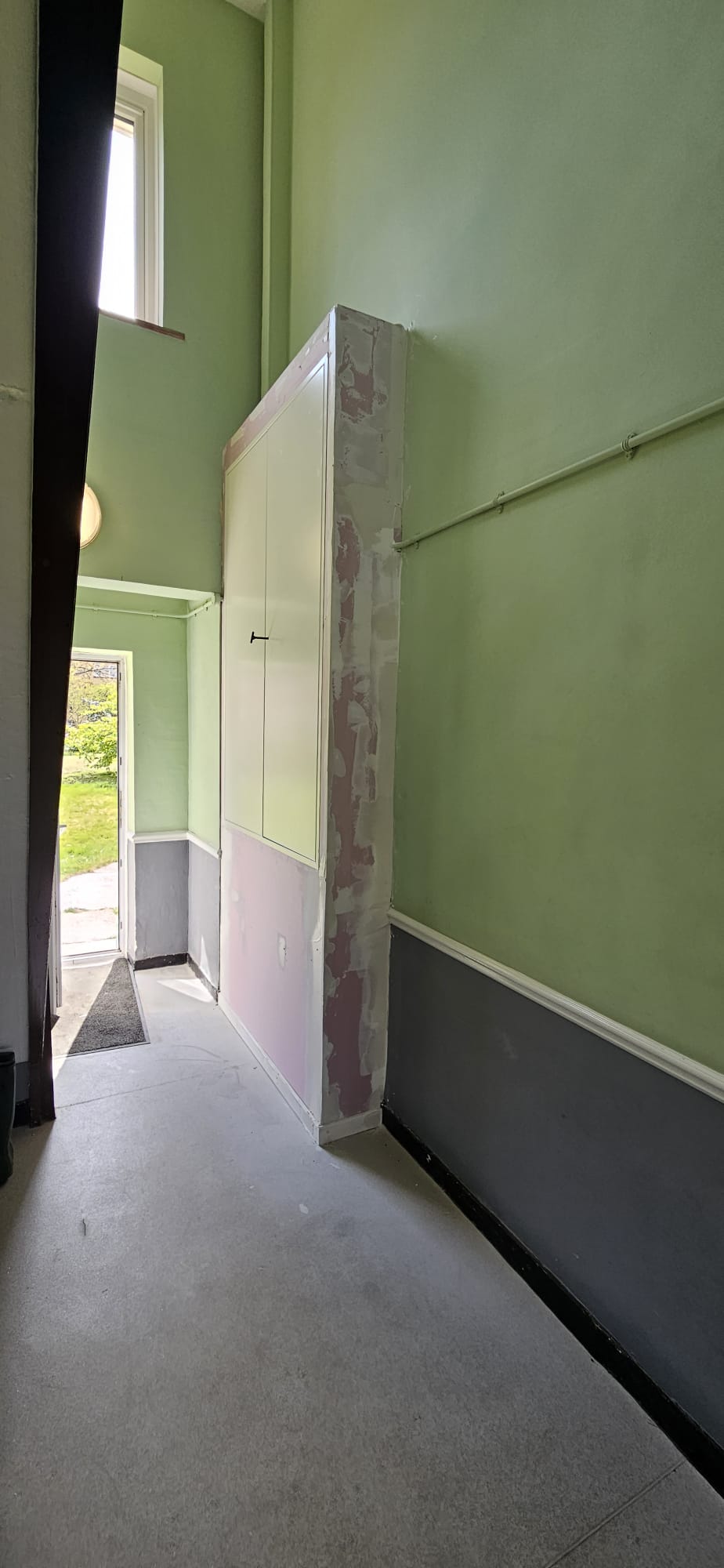 Full-height compartmentation boxing to a service riser during installation on a residential landing