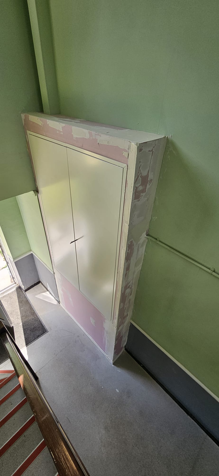 Compartmentation boxing under construction on a stairwell landing — plasterboard prior to skim and decoration
